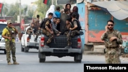 Afghan security forces transport detained prisoners who escaped from a jail after insurgents attacked a jail compound in Jalalabad, Aug. 3, 2020.
