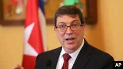 Cuba Foreign Minister Bruno Rodrigues Parrilla gestures during a news conference following his meeting with his Portuguese counterpart Augusto Santos Silva at Lisbon's Necessidades palace Wednesday, April 19, 2017. 