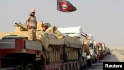 FILE - A convoy of Iraqi security forces advances on the outskirts of Mosul, Oct. 12, 2016. The battle for Mosul is weeks or perhaps days away. 