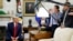 FILE - President Donald Trump talks to reporters in the Oval Office of the White House, in Washington, July 9, 2019.