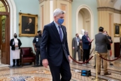 FILE - Republican Senator Bill Cassidy leaves the chamber as the Senate voted to consider hearing from witnesses in the impeachment trial of former President Donald Trump, at the Capitol in Washington, Feb. 13, 2021.