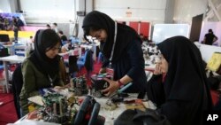 FILE - In this April 6, 2016, file photo, Iranian students prepare their robots during the international robotics competition, RoboCup Iran Open 2016, in Tehran, Iran. Universities in the U.S. say President Donald Trump&#39;s revised travel ban would block hundreds of graduate students who play key roles in research. Twenty-five of America&#39;s largest universities told The Associated Press they&#39;ve sent acceptance letters to more than 500 students from the six banned countries for next fall, mostly from Iran, who are known for their strength in engineering and sciences.