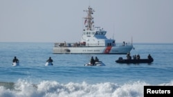 U.S. Border agents and the Coast Guard patrol the Pacific Ocean where the U.S. Mexico border wall enters the water at Border Field State Park in San Diego, California, Nov. 20, 2018. 