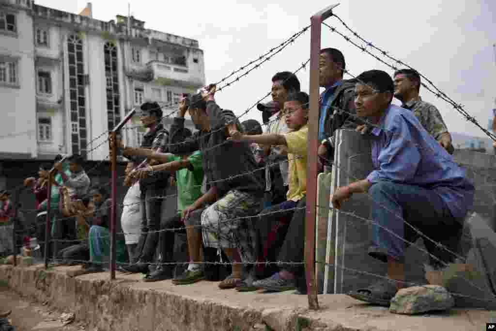 Locals gather to a rescue operation at the site of a budget hotel that collapsed in Saturday&rsquo;s earthquake, in Kalanki neighborhood of Kathmandu, Nepal.