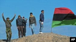 Rebel fighters at positions outside Brega, Libya, show their support for the opposition and their enthusiastic belief that they will overthrow the government in Tripoli, March 10, 2011