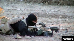 FILE - A U.S. Navy SEAL member provides cover for his teammates advancing on a suspected location of al-Qaida and Taliban forces, Jan. 26, 2002.