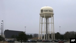 FILE - Vehicles park around a water tower at Fort Riley, Kansas, Feb. 9 2015. According to a criminal complaint filed Monday, a U.S. Army soldier has been arrested after sharing bomb-making instructions online.