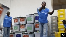 Staff organize ballot boxes from polling stations in Monrovia, Liberia, Oct. 12, 2011.