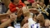 Faithful reach for Pope Francis&#39; hand, center, during an audience with Roma, Sinti and others itinerant group members, at the Vatican.