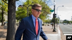 FILE - Michael Flynn, President Donald Trump's former national security adviser, leaves federal court following a status conference in Washington, Sept. 10, 2019. 
