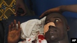 A man who says he was shot in the face by security forces loyal to Laurent Gbagbo while walking home in the Abobo neighborhood waits to receive stitches at a health clinic in the Anyama suburb of Abidjan, Ivory Coast, March 12, 2011