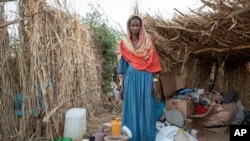 Ethiopian Tigrayan refugee 27-year-old Aksamaweet Garazgerer, who is living with HIV, stands in front of her temporary shelter at Umm Rakouba refugee camp in Qadarif, eastern Sudan, Dec. 7, 2020. 