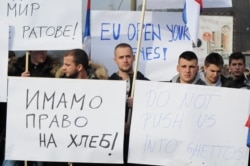FILE - People protest Kosovo's decision to raise customs tariffs on Serbian and Bosnian goods, in the village of Rudare near Mitrovica, Kosovo, Nov. 23, 2018.