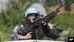 UN forces patrol outside the UN headquarters in Ivory Coast, Abidjan, Ivory Coast, Tuesday, Dec. 21, 2010.