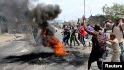 Demonstrators burn tires to set up barricades during a protest in the Democratic Republic of Congo's capital Kinshasa, Jan. 20, 2015.