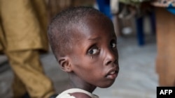 FILE - A boy suffering from severe acute malnutrition sits at one of the UNICEF nutrition clinics in the Muna settlement, which houses nearly 16,000 internally displaced people in the outskirts of Maiduguri, capital of Borno state, Nigeria, June 30, 2016.