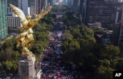 Supporters of Mexican President Andres Manuel Lopez Obrador march in Mexico City, Nov. 27, 2022.