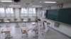 A quarantine worker sprays disinfectant at a high school, following the coronavirus disease outbreak, in Seoul, South Korea, May 11, 2020. 