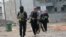 Gunmen patrol during clashes with Iraqi security forces in Fallujah, 40 miles (65 kilometers) west of Baghdad, Iraq, Jan. 5, 2014. 