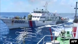 FILE - Screen grab shows Chinese Coast Guard ship 46001 (L) chasing a Vietnamese vessel near the site of a Chinese oil rig in disputed waters in the South China Sea, off Vietnam's central coast. 