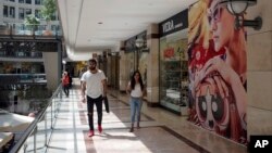 People walk in a shopping mall in Ankara, Turkey, Aug. 15, 2018. Turkey announced increased duties on U.S. products, including cars, tobacco and alcohol, on Wednesday in retaliation against U.S. sanctions and tariffs on Turkey in a continuing feud over the detention of an American pastor.