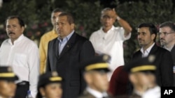 Nicaragua’s President Daniel Ortega, left, Venezuela's President Hugo Chavez, second left, Iranian President Mahmoud Ahmadinejad, second right, and Akbar Esmaeil Pour, Iran's ambassador to Nicaragua, right, stand during an honor guard presentation at Orte