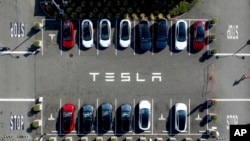 FILE - Tesla vehicles line a parking lot at the company's Fremont, Calif., factory, on Sept. 18, 2023.