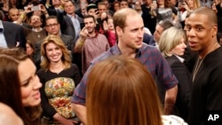 Britain's Prince William, second from right, talks with rapper and entrepreneur Jay-Z , far right, as Kate, left, the Duchess of Cambridge, chats with Jay Z's wife, entertainer Beyonce, foreground center, in New York, Dec. 8, 2014.