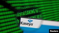 Kaseya's webpage is seen through a magnifying glass in front of displayed binary code in this illustration taken, July 6, 2021. 