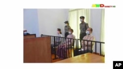 FILE - A screen grab from Myawaddy TV video shows deposed Myanmar leader Aung San Suu Kyi (center-left) and others before a special court, in Naypyitaw, Myanmar, May 24, 2021.