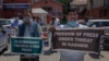 Kashmiri journalists hold placards during a protest against a new media policy that was announced last month in Srinagar, Indian controlled Kashmir, July 6, 2020.
