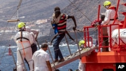 FILE - Migrants disembark at the port in Valverde at the Canary island of El Hierro, Spain, on Aug. 26, 2024, after they arrived by boat from a 13-day voyage from the coast of Senegal.