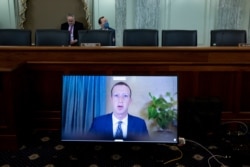 Facebook CEO Mark Zuckerberg appears on a screen as he speaks remotely during a hearing before the Senate Commerce Committee on Capitol Hill, Oct. 28, 2020, in Washington.