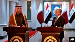 Iraqi Foreign Minister Mohamed Alhahkim, right, holds a press conference with visiting Qatari counterpart Sheikh Mohammed bin Abdulrahman Al Thani in Baghdad, Iraq, Jan. 15, 2020. 