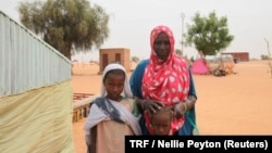 Aminetou Mint Yarg poses with family members in the commune of Dar El Barka, Mauritania, Oct. 20, 2018.