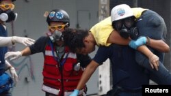 A demonstrator is carried by volunteer members of a primary care response team during a rally against Venezuelan President Nicolas Maduro's government in Caracas, Venezuela, July 1, 2017.