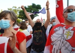 Belarus citizens in Poland demonstrate during a solidarity rally in front of the Belarusian Embassy before the upcoming presidential election, in Warsaw, Aug. 7, 2020. Belarus will hold its presidential election on Aug. 9.