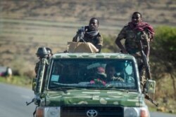 Ethiopian government soldiers ride in the back of a truck on a road near Agula, in the Tigray region of northern Ethiopia, May 8, 2021.