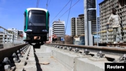 FILE - A worker walks along a metro line construction project in Addis Ababa, Ethiopia, Feb. 7, 2015. 