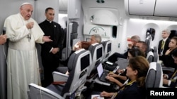 Pope Francis talks to journalists during a press conference aboard a plane to Rome at the end of his visit to Colombia, Sept. 11, 2017.