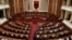 FILE - Albania's Prime Minister Edi Rama delivers a speech to the parliament with the seats of the main opposition Democratic party, left, empty, during an assembly session in Tirana, Feb. 23, 2017.