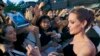 FILE - Angelina Jolie, soon to direct a film about Kenyan icon Richard Leakey, greets fans at the Tokyo premiere of "Maleficent," June 23, 2014. 