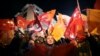 Supporters of President Recep Tayyip Erdogan wave flags in Istanbul, Sunday, March 31, 2019. 