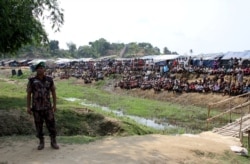 FILE - A Bangladeshi soldier stands guard near a refugee camp in Cox's Bazar, Bangladesh, housing Rohingya refugees from Myanmar's Rakhine state, April 29, 2018.