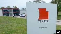 FILE - Signage outside Takata Ignition Systems GmbH in Schoenebeck, Germany.