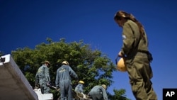 Israeli soldiers from the Home Front Command take part in a drill simulating a building collapse following a mock rocket attack at Zikim army base, near the southern city of Ashkelon, June 19, 2011