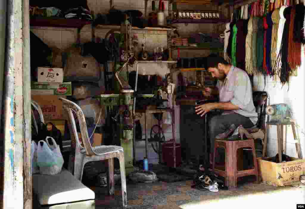 A cobbler busy at work. (J. Weeks/VOA)