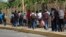FILE - Central American migrants cross into Mexico from Guatemala, near Ciudad Hidalgo, Mexico, June 4, 2019. The migrants walked over the bridge and waited to register at a Mexican immigration office.