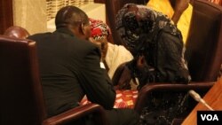 Rescued "Chibok girl" Amina Ali is shown seated and wearing a veil before a news conference at the presidential villa in Abuja, Nigeria, May 19, 2016. (C. Stein/VOA)