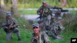 FILE - Russian soldiers take part in a competition, part of Army Games, outside Novosibirsk, 2900 km (some 1800 miles) east of Moscow, Russia, Aug. 2, 2017.